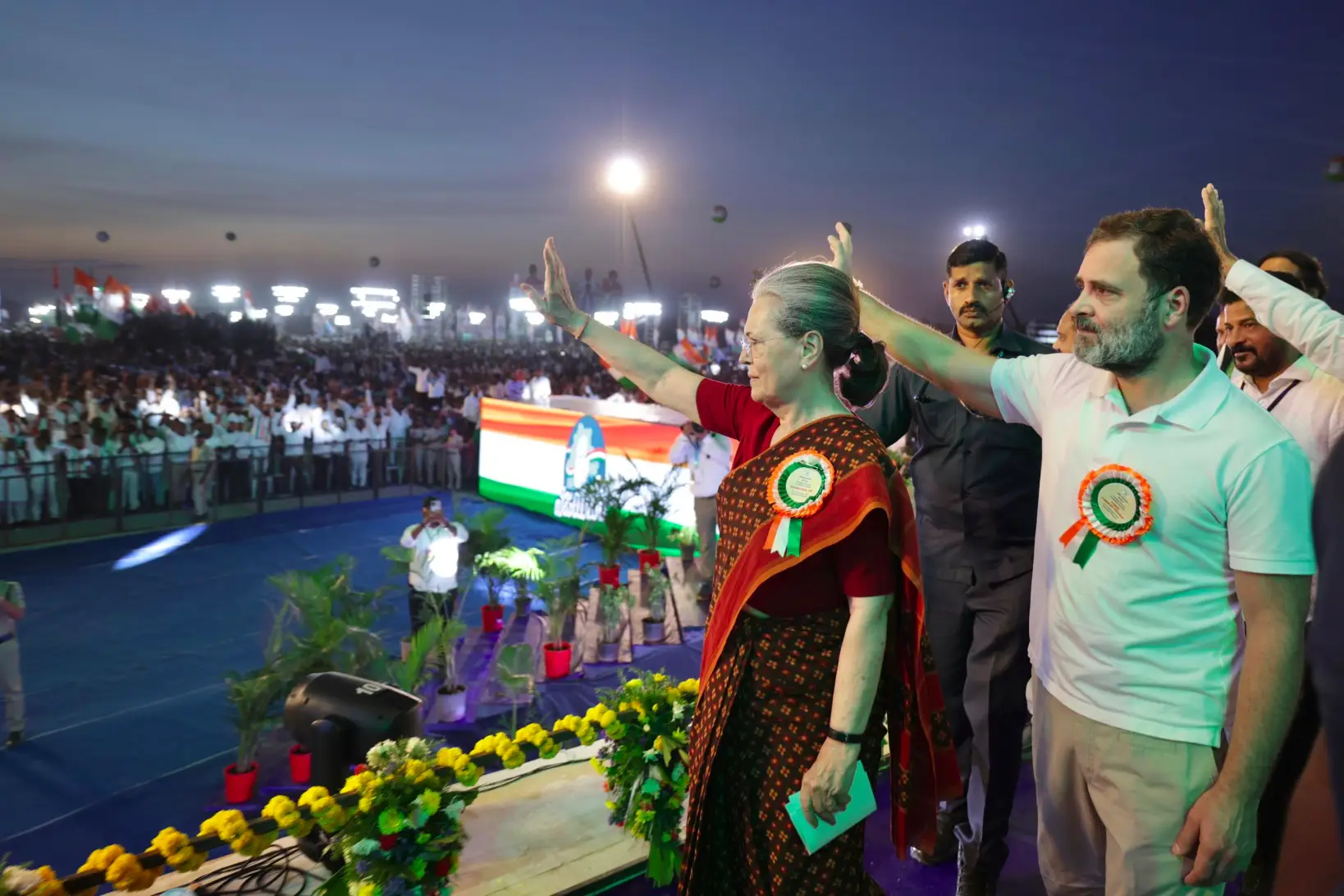 Sonia gandhi and rahul waiving at a rally in Telangana.